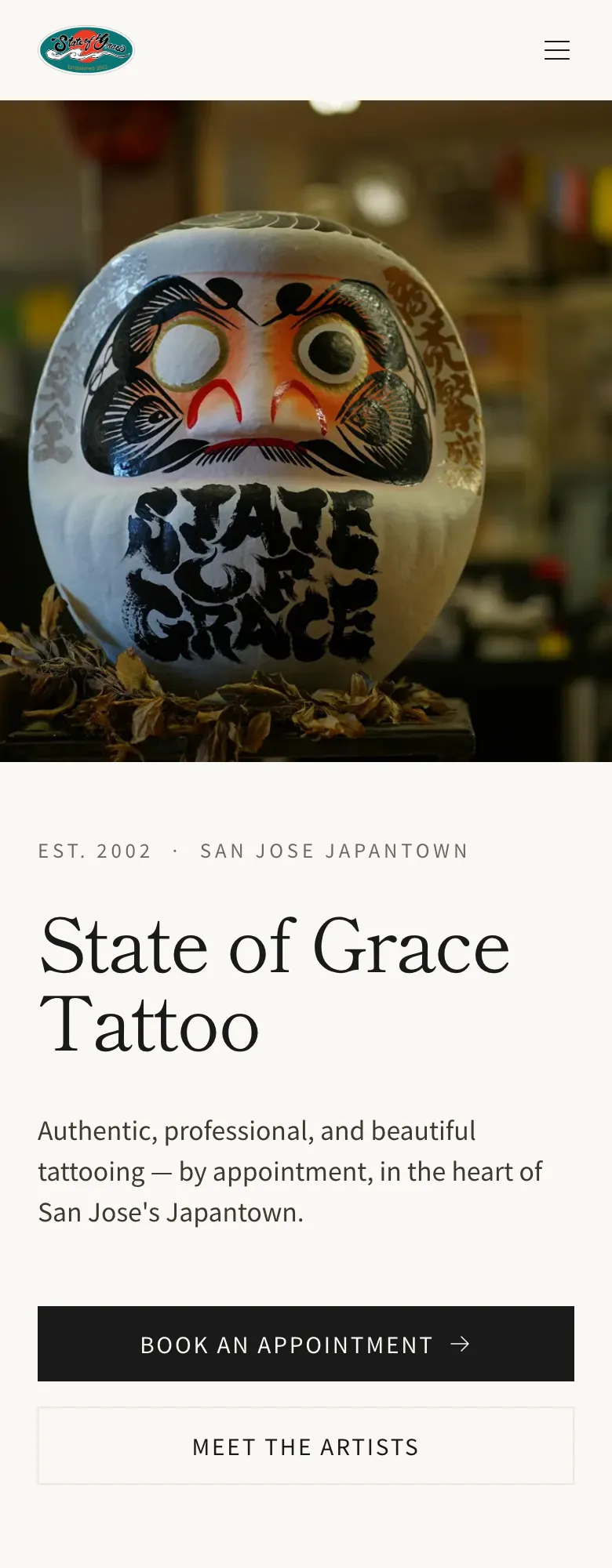 State of Grace Tattoo home page on a phone